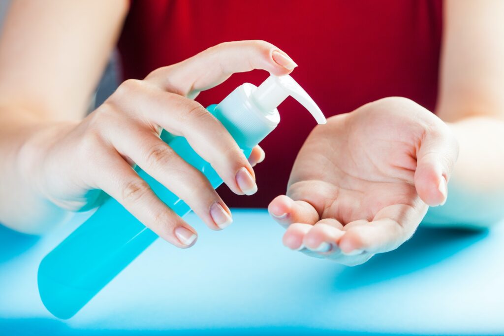Caucasian woman applying dry hand wash sanitizer gel