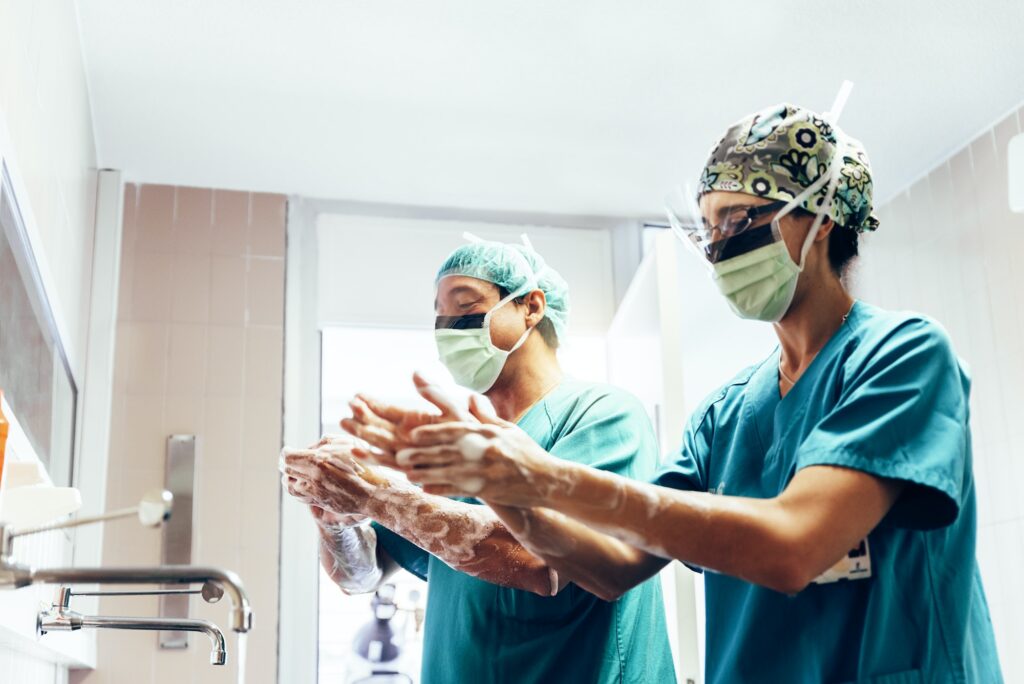 Couple of Surgeons Washing Hands Before Operating.