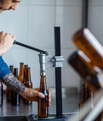 Drink production, employee works on beer manufacturing, craft plant Drink production, employee works on beer manufacturing, craft plant