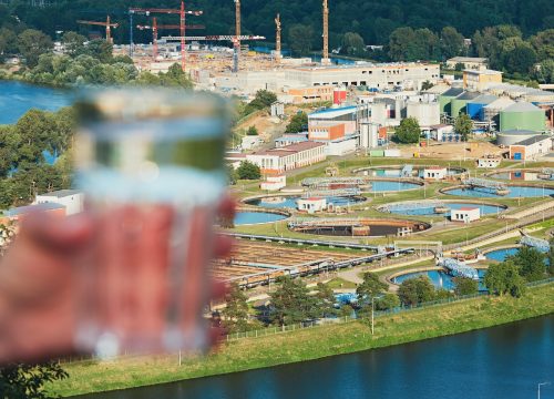 Glass of drinking water and sewage treatment plant Glass of drinking water and sewage treatment plant